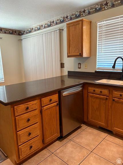 1579 W 2050 N, Clinton, UT 84015 - kitchen with stainless steel dishwasher, a peninsula, dark countertops, and light tile patterned floors