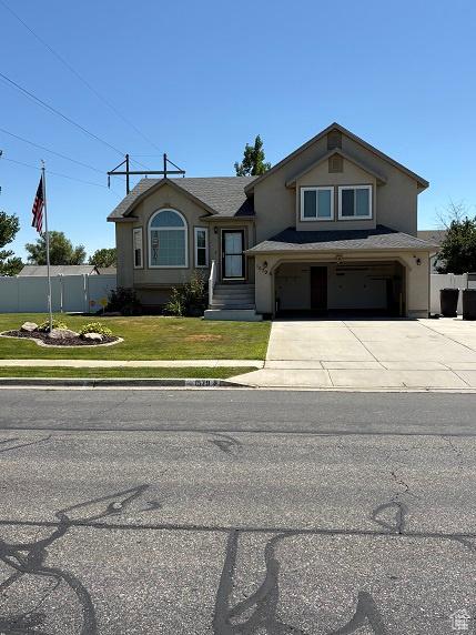 1579 W 2050 N, Clinton, UT 84015 - view of front of property featuring driveway, stucco siding, and a garage
