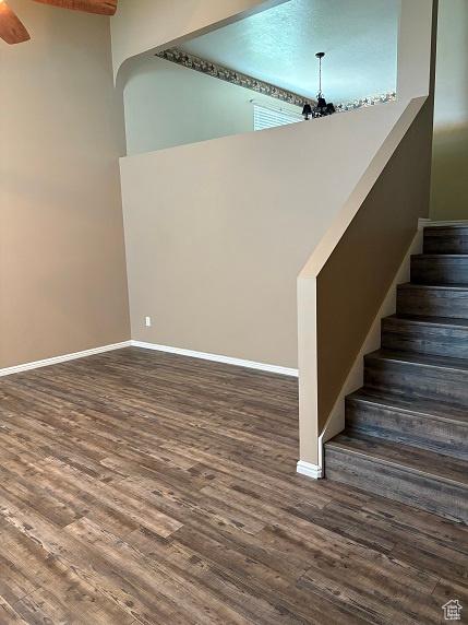 1579 W 2050 N, Clinton, UT 84015 - staircase with a chandelier, wood finished floors, ceiling fan, and a towering ceiling