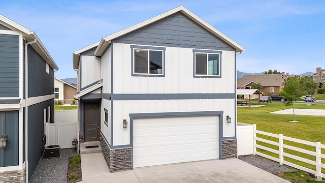 8687 N Oakmont Aly, Eagle Mountain, UT 84005 - view of front of property with stone siding, an attached garage, driveway, and board and batten siding