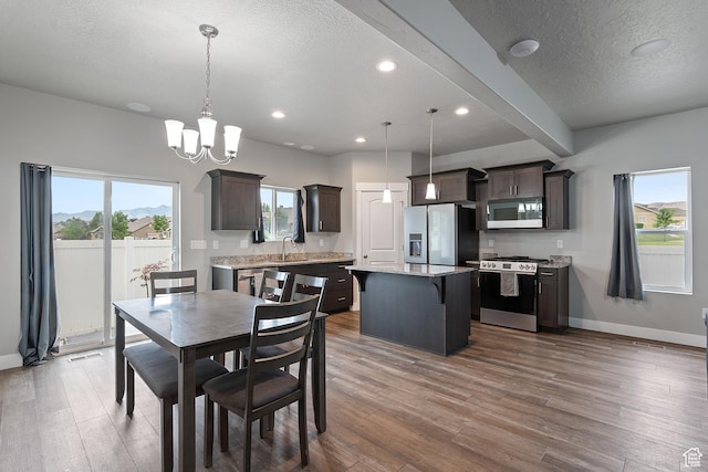 8687 N Oakmont Aly, Eagle Mountain, UT 84005 - dining area featuring wood finished floors, a chandelier, a textured ceiling, and recessed lighting