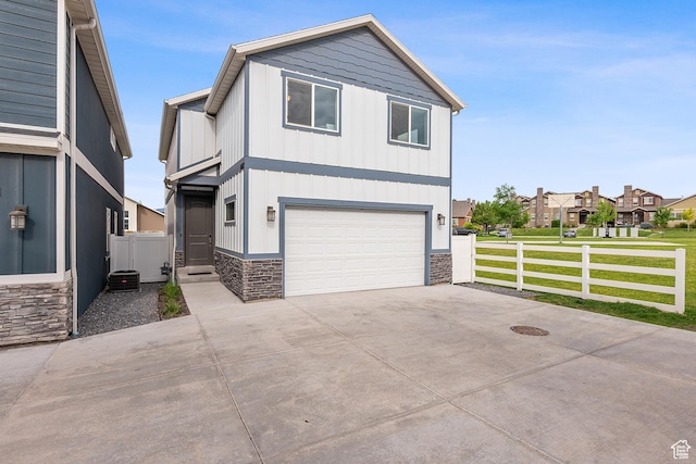 8687 N Oakmont Aly, Eagle Mountain, UT 84005 - view of front of home featuring stone siding, board and batten siding, an attached garage, and concrete driveway