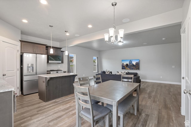 8687 N Oakmont Aly, Eagle Mountain, UT 84005 - dining room with light wood-style flooring, a chandelier, and recessed lighting