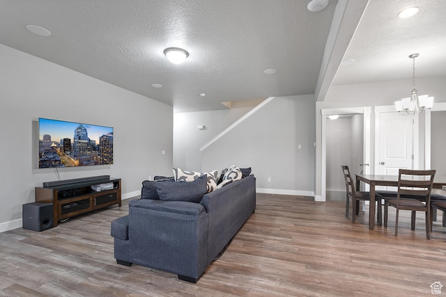 8687 N Oakmont Aly, Eagle Mountain, UT 84005 - living room with a textured ceiling, wood finished floors, a chandelier, and stairway