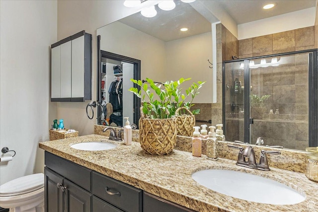 3944 W Sage Blossom Way S, Jordan, UT 84009 - bathroom featuring double vanity, a shower stall, and a spacious closet