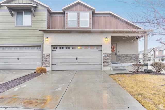 3944 W Sage Blossom Way S, Jordan, UT 84009 - view of front of property with stone siding, driveway, an attached garage, and stucco siding