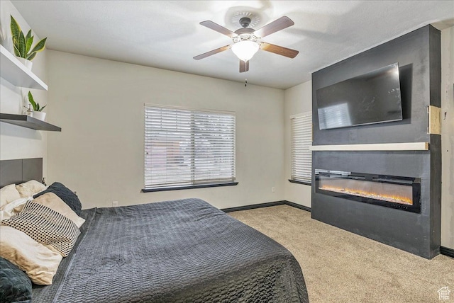 3944 W Sage Blossom Way S, Jordan, UT 84009 - bedroom featuring a glass covered fireplace, carpet floors, and a ceiling fan