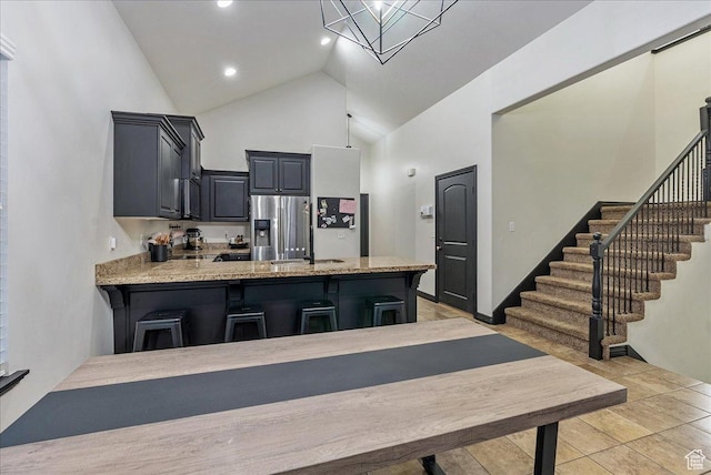 3944 W Sage Blossom Way S, Jordan, UT 84009 - kitchen featuring high vaulted ceiling, a peninsula, a breakfast bar, recessed lighting, and stainless steel refrigerator with ice dispenser