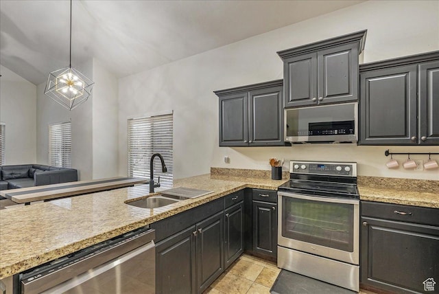 3944 W Sage Blossom Way S, Jordan, UT 84009 - kitchen with appliances with stainless steel finishes, a peninsula, open floor plan, hanging light fixtures, and vaulted ceiling