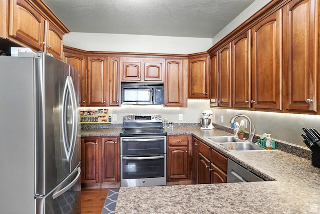 1492 N 565 W Unit 101, Logan, UT 84341 - kitchen with appliances with stainless steel finishes, dark wood finished floors, and brown cabinets