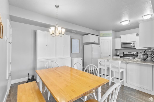 217 W Ridge Rd, Saratoga Springs, UT 84045 - dining area featuring wood finished floors and a chandelier