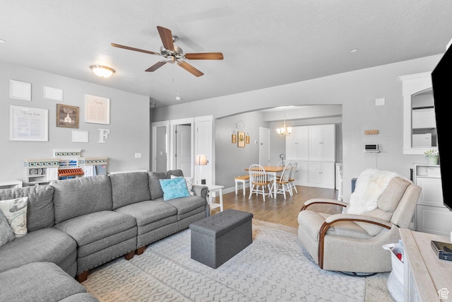 217 W Ridge Rd, Saratoga Springs, UT 84045 - living area featuring wood finished floors, a ceiling fan, and arched walkways