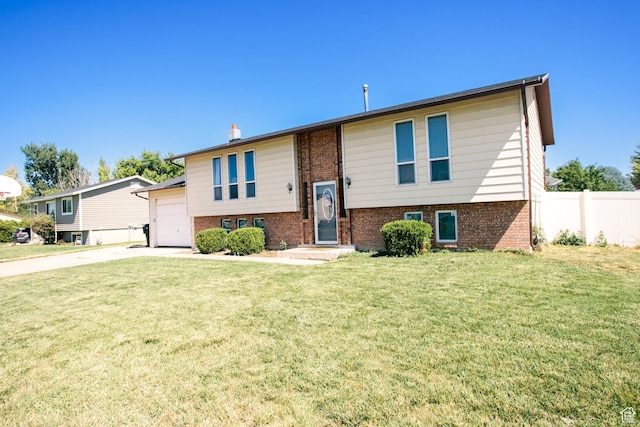 2080 W 2175 S, Syracuse, UT 84075 - split foyer home featuring brick siding, a garage, concrete driveway, and a chimney