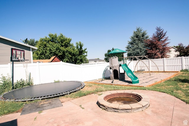2080 W 2175 S, Syracuse, UT 84075 - fenced backyard with a fire pit, a patio, a playground, and a trampoline