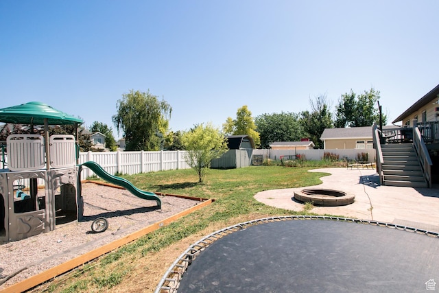 2080 W 2175 S, Syracuse, UT 84075 - fenced backyard with an outdoor fire pit, stairs, a playground, a shed, and a patio area