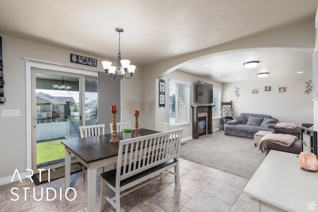2185 N 250 W, Harrisville, UT 84414 - tiled dining space with carpet, arched walkways, a chandelier, and plenty of natural light