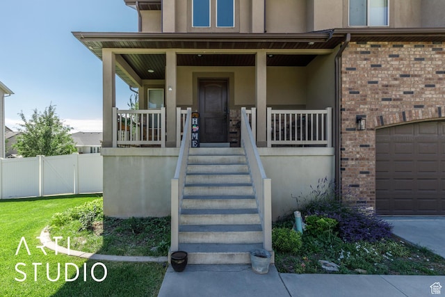 2185 N 250 W, Harrisville, UT 84414 - doorway to property featuring stucco siding, a porch, and an attached garage