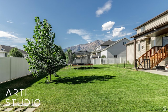 2185 N 250 W, Harrisville, UT 84414 - fenced backyard with a trampoline, a mountain view, and a residential view