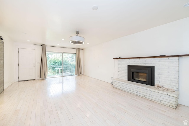 460 S 1074 E, Provo, UT 84606 - unfurnished living room featuring a fireplace, light wood-style floors, and recessed lighting