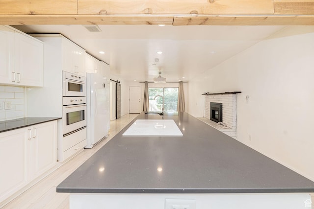 460 S 1074 E, Provo, UT 84606 - kitchen featuring dark countertops, a fireplace, white cabinets, white appliances, and recessed lighting