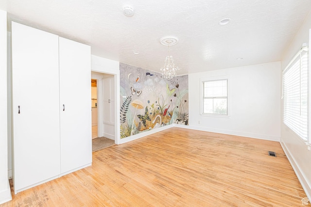460 S 1074 E, Provo, UT 84606 - unfurnished room featuring a chandelier, light wood-style flooring, a smoke detector, and a textured ceiling