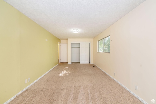 460 S 1074 E, Provo, UT 84606 - unfurnished bedroom with light carpet, a textured ceiling, and a closet
