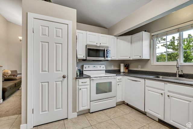 1492 N 1040 W, Orem, UT 84057 - kitchen with white appliances, white cabinetry, dark countertops, and light tile patterned flooring