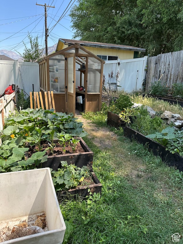 503 S Utah Ave, Provo, UT 84606 - fenced backyard with a greenhouse, a vegetable garden, and an outbuilding