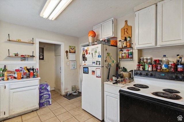 3221 Porter Ave, Ogden, UT 84403 - kitchen featuring range with electric stovetop, freestanding refrigerator, light countertops, light tile patterned flooring, and white cabinets