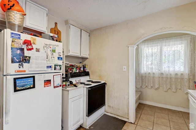 3221 Porter Ave, Ogden, UT 84403 - kitchen with white appliances, white cabinets, light tile patterned floors, and light countertops