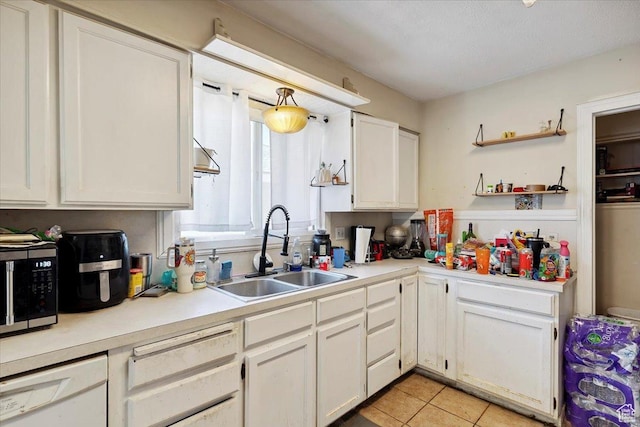 3221 Porter Ave, Ogden, UT 84403 - kitchen with dishwasher, white cabinets, light countertops, light tile patterned floors, and open shelves