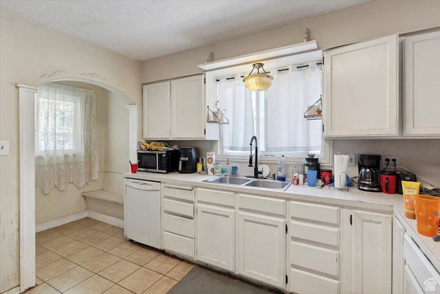 3221 Porter Ave, Ogden, UT 84403 - kitchen with white dishwasher, healthy amount of natural light, light tile patterned floors, and white cabinetry