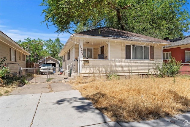 3221 Porter Ave, Ogden, UT 84403 - bungalow-style home featuring driveway, a detached garage, and a gate