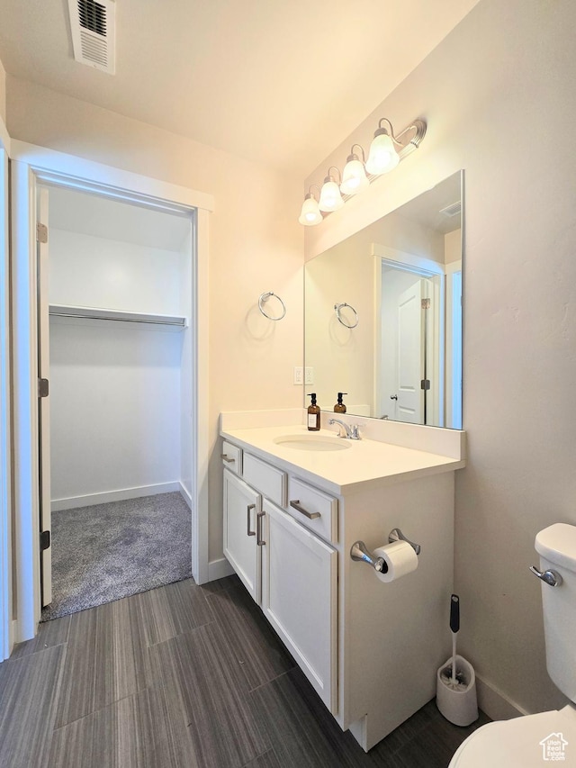 5149 W Arley Ct, Herriman, UT 84096 - bathroom featuring vanity, wood finished floors, and a walk in closet