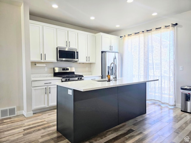 5149 W Arley Ct, Herriman, UT 84096 - kitchen with stainless steel appliances, light wood-style floors, white cabinetry, and recessed lighting