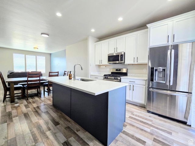 5149 W Arley Ct, Herriman, UT 84096 - kitchen with stainless steel appliances, light wood-type flooring, an island with sink, white cabinetry, and recessed lighting