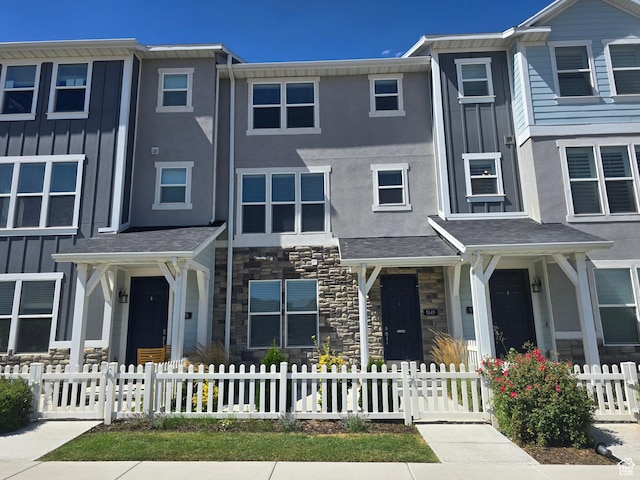 5149 W Arley Ct, Herriman, UT 84096 - view of property featuring stone siding, stucco siding, and a fenced front yard