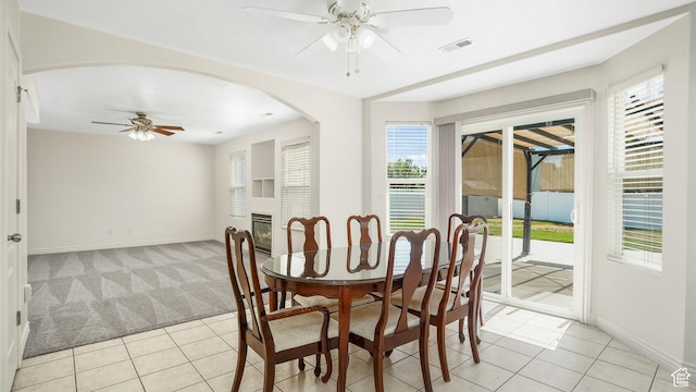 1238 S 1420 W, Woods Cross, UT 84087 - dining area featuring a ceiling fan, light tile patterned flooring, healthy amount of natural light, and arched walkways