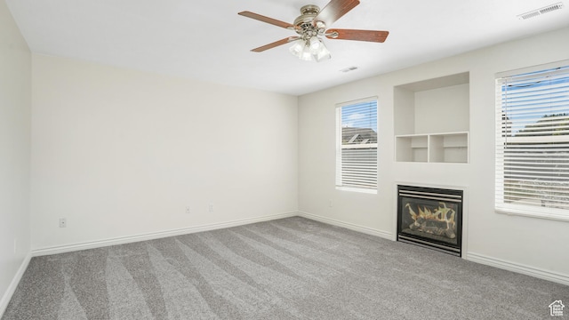 1238 S 1420 W, Woods Cross, UT 84087 - unfurnished living room featuring carpet flooring, a glass covered fireplace, and ceiling fan