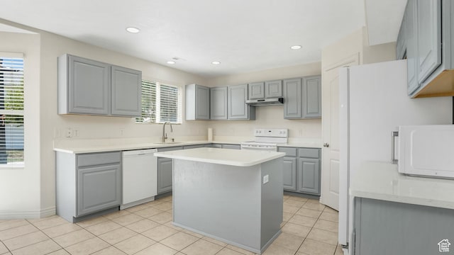 1238 S 1420 W, Woods Cross, UT 84087 - kitchen with white appliances, gray cabinetry, light countertops, under cabinet range hood, and light tile patterned floors