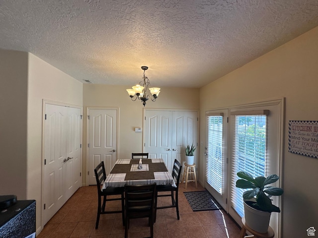 5551 W Geronimo Way S, West Jordan, UT 84081 - dining room featuring a chandelier, tile patterned floors, and a textured ceiling
