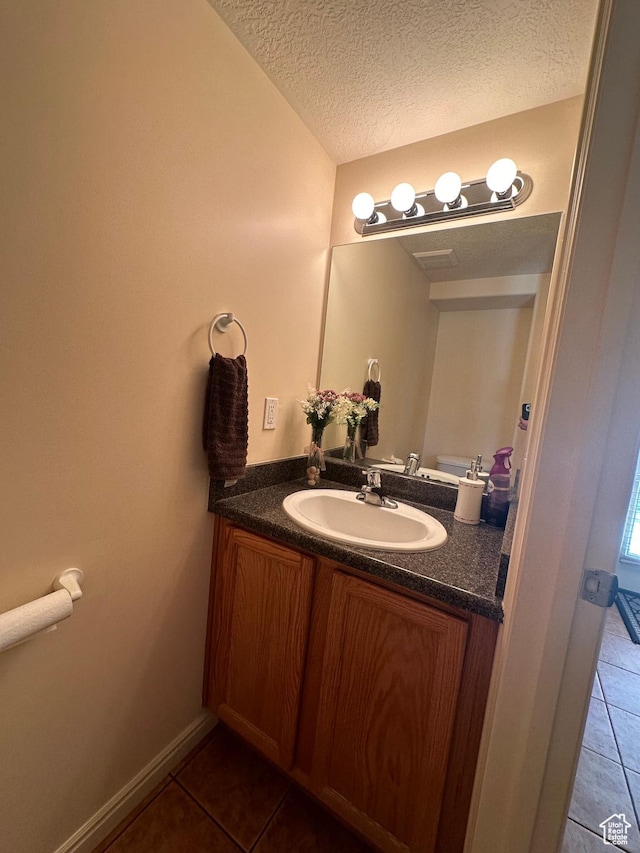 5551 W Geronimo Way S, West Jordan, UT 84081 - half bath with tile patterned flooring, vanity, and a textured ceiling