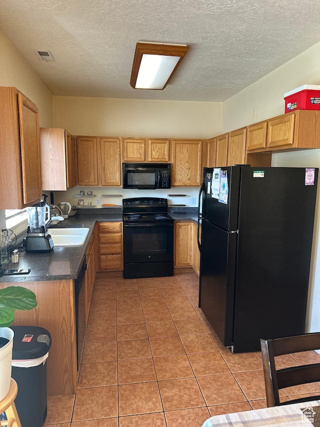 5551 W Geronimo Way S, West Jordan, UT 84081 - kitchen with black appliances, dark countertops, a textured ceiling, and light tile patterned floors
