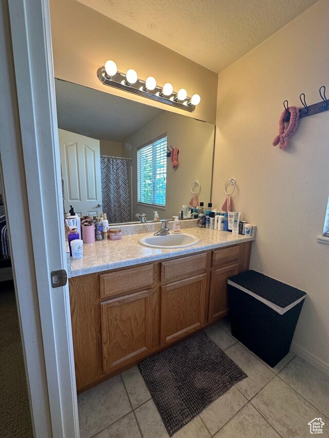 5551 W Geronimo Way S, West Jordan, UT 84081 - full bath featuring vanity, tile patterned floors, and a textured ceiling