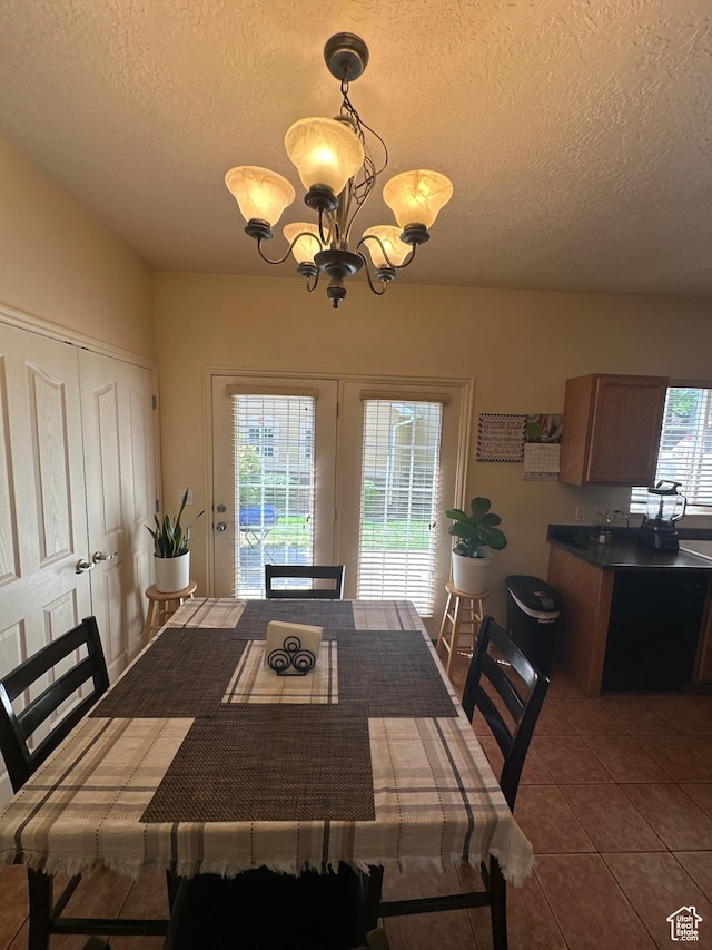 5551 W Geronimo Way S, West Jordan, UT 84081 - dining room with a textured ceiling, healthy amount of natural light, a chandelier, and dark tile patterned flooring