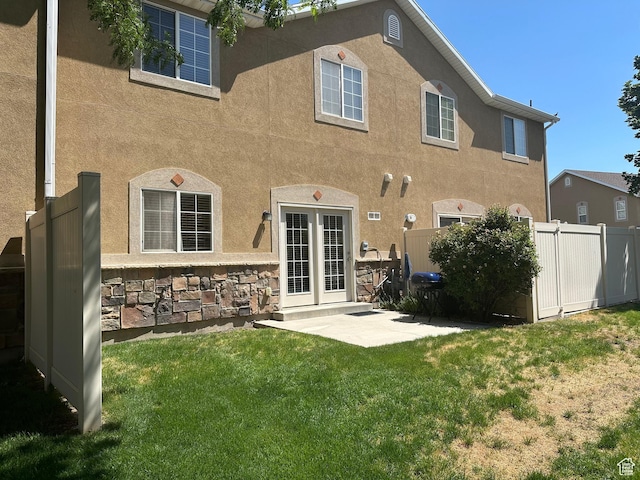 5551 W Geronimo Way S, West Jordan, UT 84081 - rear view of house featuring stucco siding and a patio
