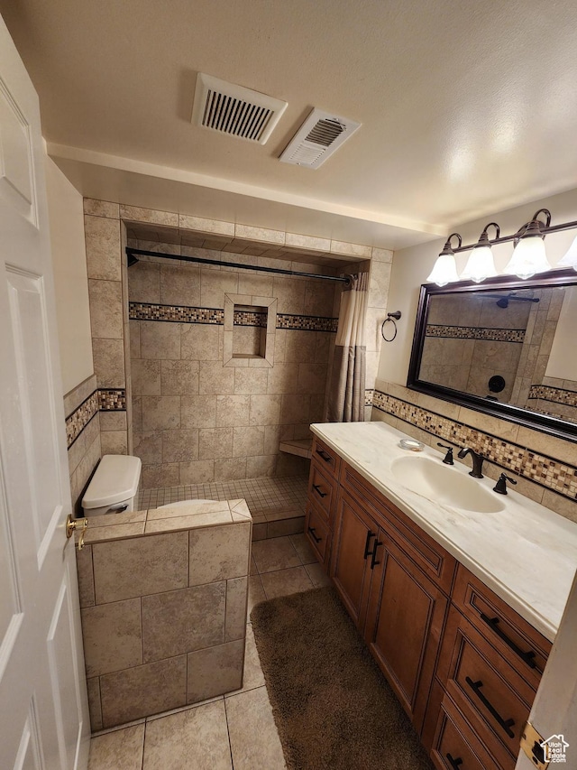 8857 S Capella Way E, Sandy, UT 84093 - full bathroom with tile patterned flooring, a tile shower, vanity, and decorative backsplash
