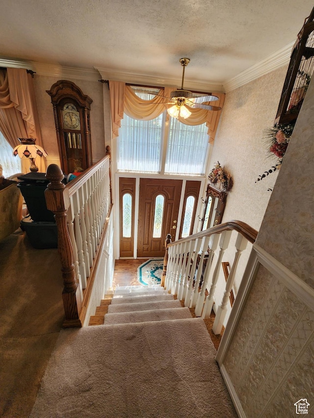 8857 S Capella Way E, Sandy, UT 84093 - carpeted entryway featuring ornamental molding, a textured ceiling, and a ceiling fan