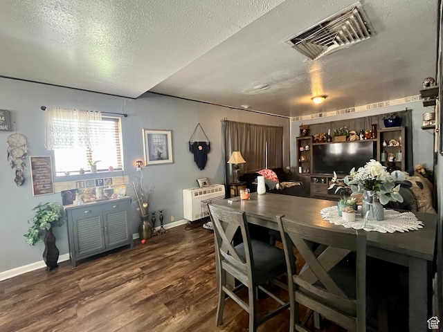 221 E 200 N, Moab, UT 84532 - dining space featuring a textured ceiling, wood finished floors, and heating unit