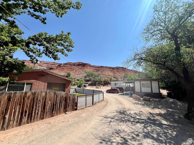 221 E 200 N, Moab, UT 84532 - view of dirt / gravel driveway with a mountain view and a gate